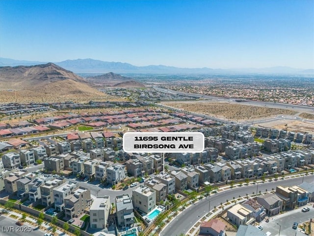11695 Gentle Birdsong Ave, Las Vegas, NV 89138 - aerial overview of property's location with a mountain backdrop and nearby suburban area
