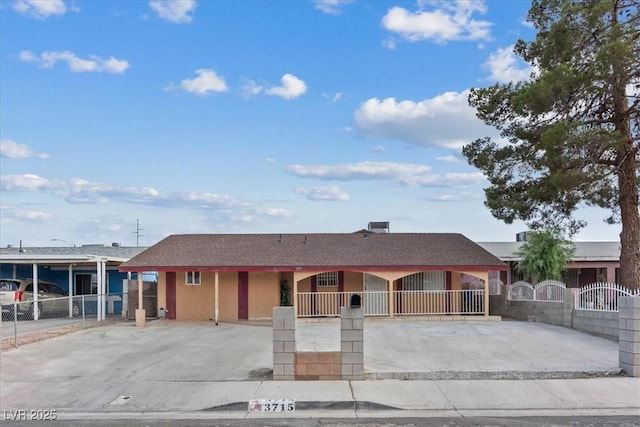 3715 Tabor Ave, North Las Vegas, NV 89030 - view of front facade with a fenced front yard, concrete driveway, and a gate