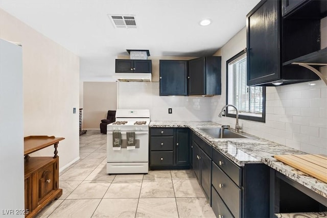 3715 Tabor Ave, North Las Vegas, NV 89030 - kitchen featuring gas range gas stove, backsplash, light stone countertops, and exhaust hood
