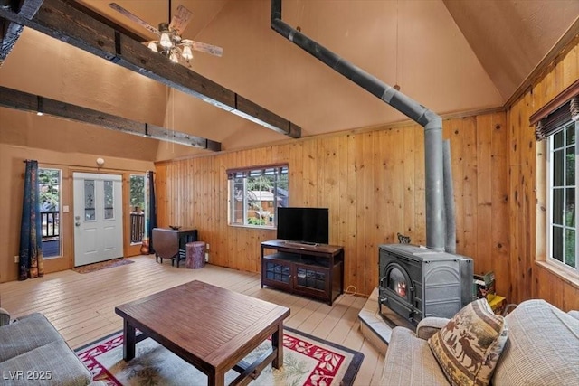 4581 Aspen Ave, Mount Charleston, NV 89124 - living area with a wood stove, hardwood / wood-style floors, ceiling fan, wooden walls, and high vaulted ceiling
