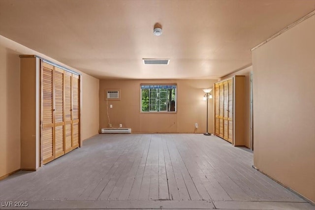 4581 Aspen Ave, Mount Charleston, NV 89124 - unfurnished room featuring light wood-type flooring, baseboard heating, and a wall unit AC