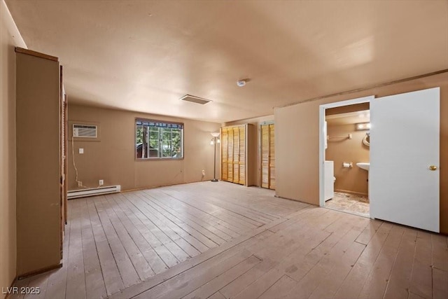 4581 Aspen Ave, Mount Charleston, NV 89124 - empty room featuring a baseboard radiator, light wood-type flooring, and a wall mounted AC