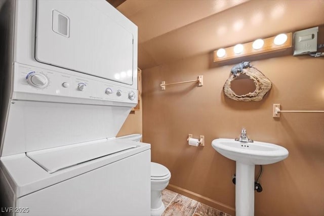 4581 Aspen Ave, Mount Charleston, NV 89124 - bathroom with stacked washer / dryer and toilet