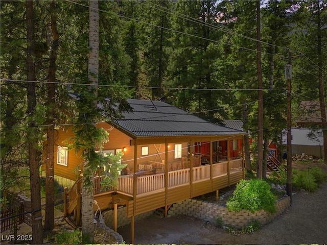 4581 Aspen Ave, Mount Charleston, NV 89124 - rear view of house with a wooden deck, a forest view, and a metal roof