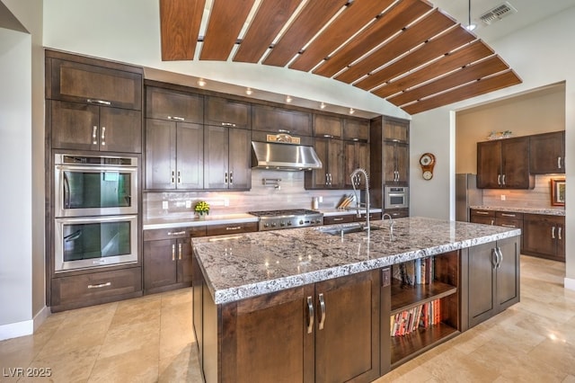 583 Saint Croix St, Henderson, NV 89012 - kitchen with appliances with stainless steel finishes, range hood, tasteful backsplash, open shelves, and lofted ceiling