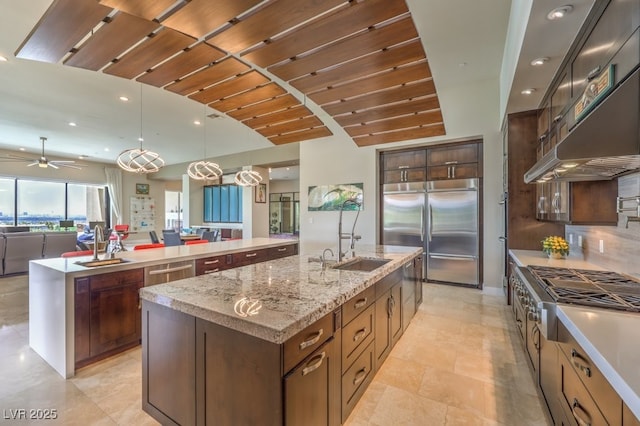 583 Saint Croix St, Henderson, NV 89012 - kitchen featuring appliances with stainless steel finishes, a spacious island, open floor plan, range hood, and recessed lighting