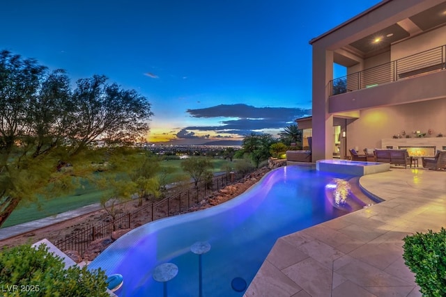 583 Saint Croix St, Henderson, NV 89012 - pool at dusk featuring a patio area and a pool with connected hot tub
