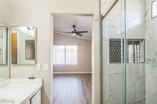 2229 Bowstring Dr, Las Vegas, NV 89142 - full bathroom featuring vaulted ceiling, a marble finish shower, wood finished floors, a ceiling fan, and ornamental molding