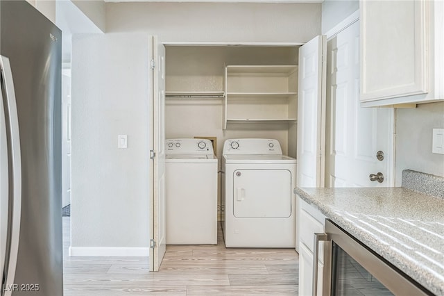 2229 Bowstring Dr, Las Vegas, NV 89142 - washroom featuring wine cooler, washing machine and dryer, and light wood-style flooring
