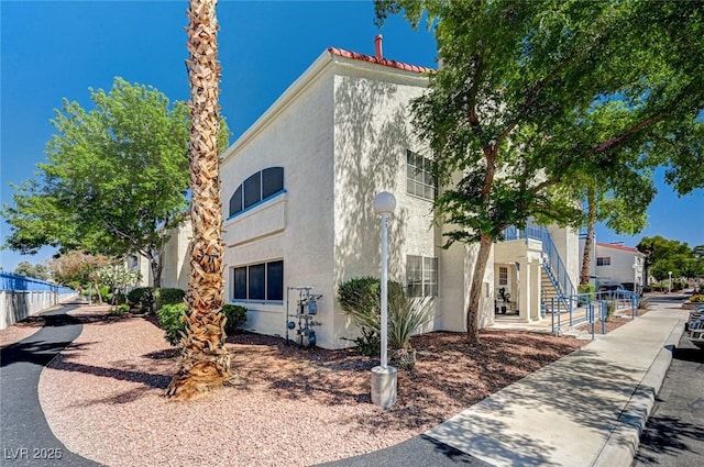2725 S Nellis Blvd Unit 2036, Las Vegas, NV 89121 - view of side of property featuring stucco siding and stairs
