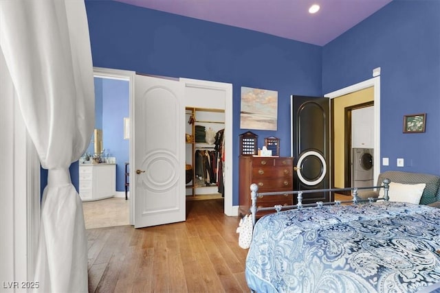 2200 Glenbrook Way, Las Vegas, NV 89117 - bedroom with hardwood / wood-style floors, washer / dryer, a walk in closet, and a closet