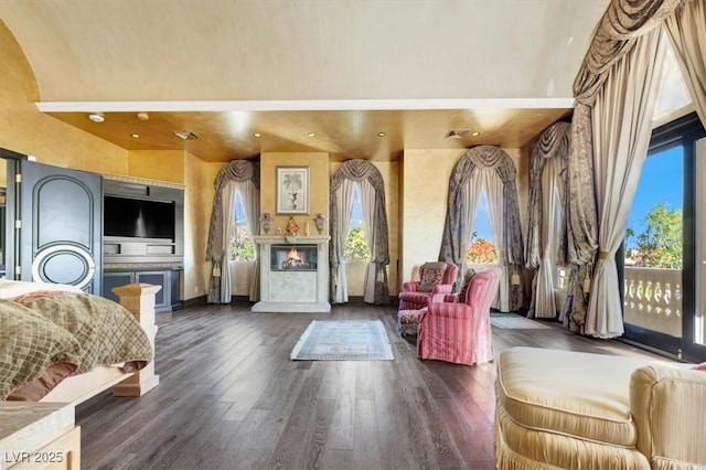 2200 Glenbrook Way, Las Vegas, NV 89117 - bedroom featuring access to exterior, a glass covered fireplace, dark wood-style floors, and a towering ceiling