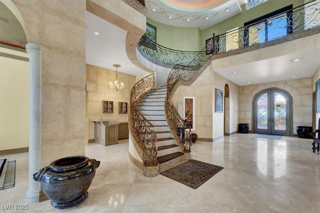 2200 Glenbrook Way, Las Vegas, NV 89117 - foyer with a high ceiling, french doors, stairs, arched walkways, and decorative columns