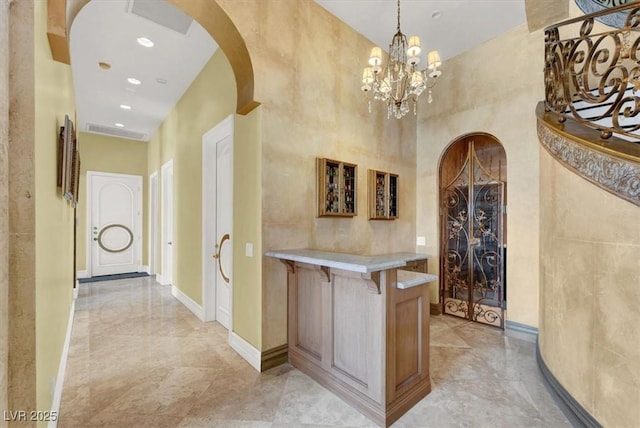 2200 Glenbrook Way, Las Vegas, NV 89117 - wine room featuring arched walkways, light marble finish flooring, a chandelier, and recessed lighting
