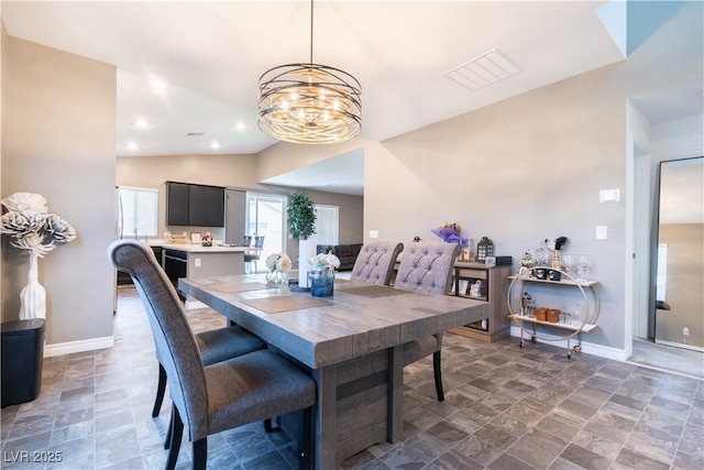 4376 Latitude Valley Ct, North Las Vegas, NV 89084 - dining space featuring lofted ceiling, a chandelier, and stone finish flooring