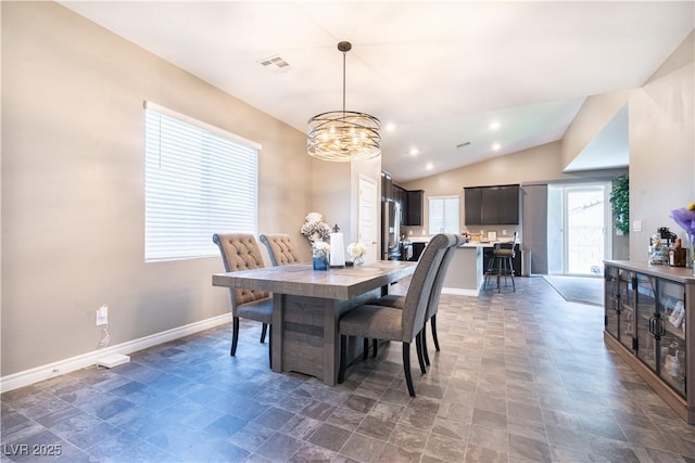 4376 Latitude Valley Ct, North Las Vegas, NV 89084 - dining area with a chandelier, vaulted ceiling, and stone finish flooring