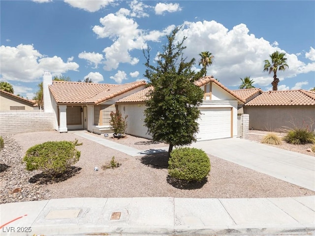 317 Brent Ct, Henderson, NV 89074 - view of front of house with stucco siding, a garage, a tiled roof, and concrete driveway