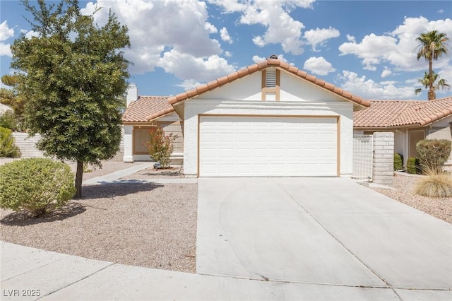 317 Brent Ct, Henderson, NV 89074 - mediterranean / spanish house featuring a garage, driveway, stucco siding, and a tile roof