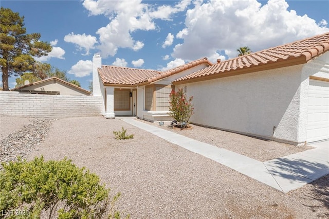 317 Brent Ct, Henderson, NV 89074 - mediterranean / spanish house with stucco siding, an attached garage, and a tiled roof