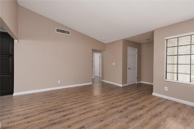 317 Brent Ct, Henderson, NV 89074 - empty room with light wood-style flooring and lofted ceiling