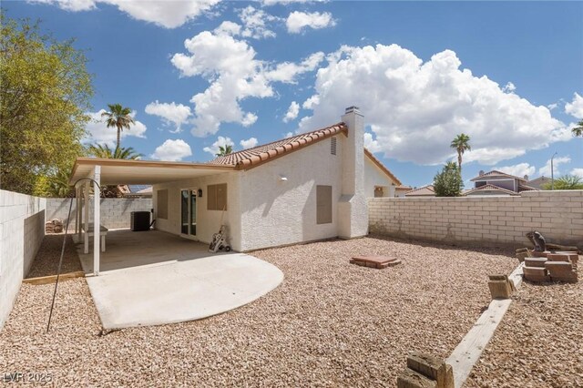 317 Brent Ct, Henderson, NV 89074 - rear view of property with stucco siding, a tile roof, a fenced backyard, and a chimney