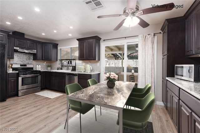 317 Brent Ct, Henderson, NV 89074 - kitchen with stainless steel appliances, under cabinet range hood, recessed lighting, light wood-style floors, and ceiling fan