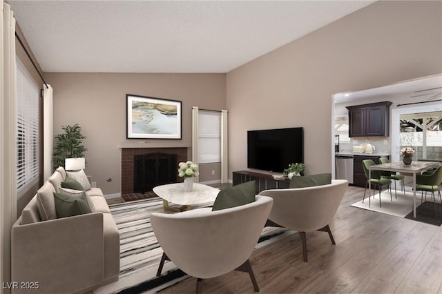 317 Brent Ct, Henderson, NV 89074 - living room with lofted ceiling, wood finished floors, and a fireplace