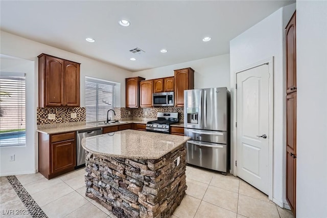 10428 Mulvaney Cir, Las Vegas, NV 89141 - kitchen with stainless steel appliances, backsplash, light tile patterned floors, a center island, and recessed lighting