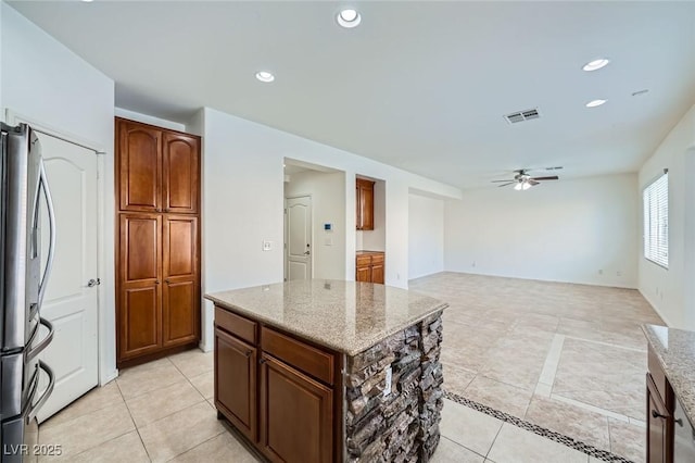 10428 Mulvaney Cir, Las Vegas, NV 89141 - kitchen featuring freestanding refrigerator, ceiling fan, light tile patterned flooring, light stone countertops, and recessed lighting