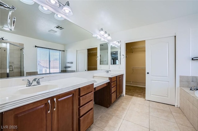 10428 Mulvaney Cir, Las Vegas, NV 89141 - bathroom with double vanity, a stall shower, tile patterned flooring, a bath, and a walk in closet
