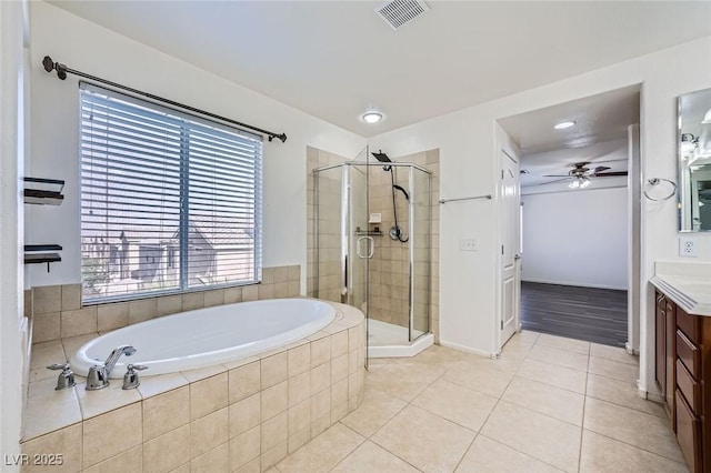 10428 Mulvaney Cir, Las Vegas, NV 89141 - full bath featuring vanity, a bath, a shower stall, tile patterned floors, and ceiling fan