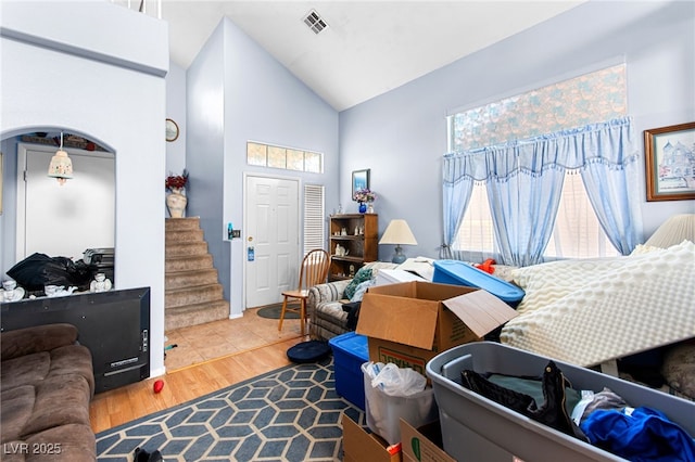 5539 Foxtail Ridge St, North Las Vegas, NV 89031 - living room with high vaulted ceiling, plenty of natural light, arched walkways, wood finished floors, and stairway