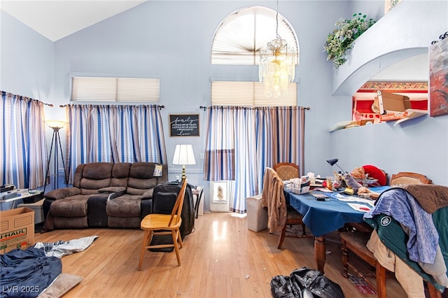 5539 Foxtail Ridge St, North Las Vegas, NV 89031 - living room featuring high vaulted ceiling, wood finished floors, and a chandelier