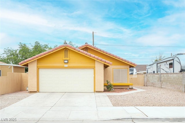 4616 E Idaho Ave, Las Vegas, NV 89104 - ranch-style home with a tiled roof, a garage, concrete driveway, and stucco siding