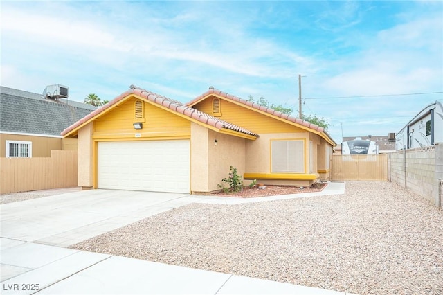4616 E Idaho Ave, Las Vegas, NV 89104 - view of front of property featuring a tile roof, an attached garage, stucco siding, and concrete driveway