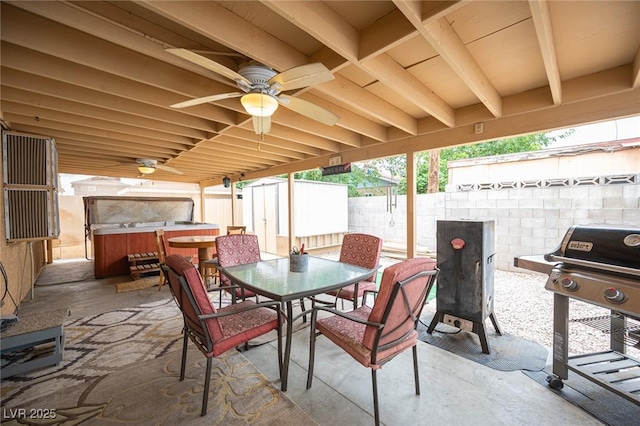 4616 E Idaho Ave, Las Vegas, NV 89104 - fenced backyard with a hot tub, outdoor dining area, a patio area, ceiling fan, and grilling area