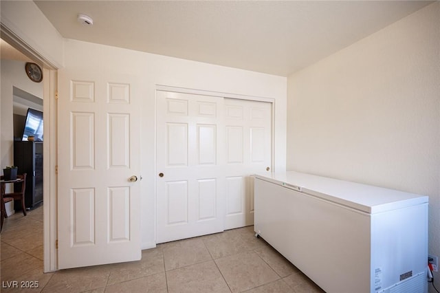 4616 E Idaho Ave, Las Vegas, NV 89104 - unfurnished bedroom featuring fridge, light tile patterned floors, and a closet