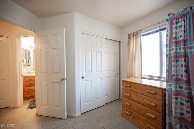 4616 E Idaho Ave, Las Vegas, NV 89104 - bedroom featuring multiple windows, light tile patterned flooring, and a closet