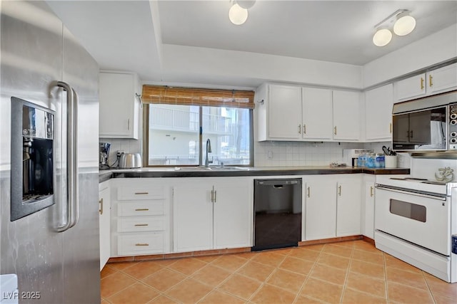 205 E Harmon Ave Unit 306, Las Vegas, NV 89169 - kitchen with stainless steel appliances, tasteful backsplash, dark countertops, and white cabinets