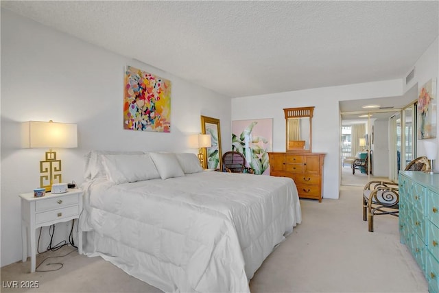 205 E Harmon Ave Unit 306, Las Vegas, NV 89169 - bedroom with light carpet and a textured ceiling
