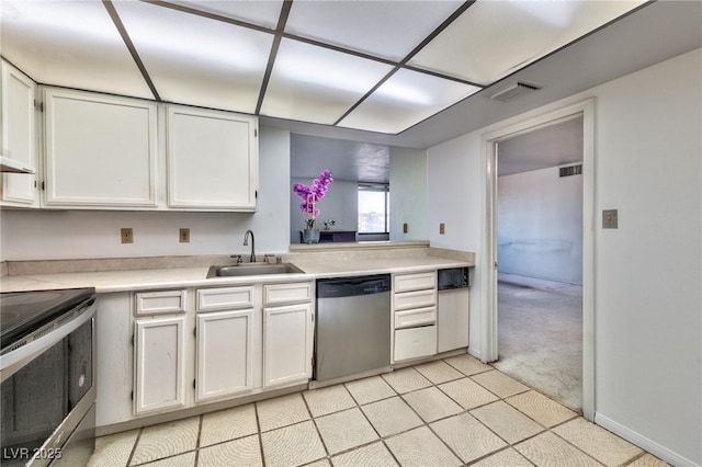 3930 University Center Dr Unit 412, Las Vegas, NV 89119 - kitchen featuring stainless steel appliances, light countertops, white cabinetry, and light carpet