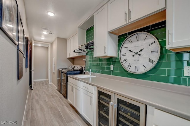 4336 Guava Ct Unit 0, Las Vegas, NV 89135 - kitchen with separate washer and dryer, white cabinets, and tasteful backsplash