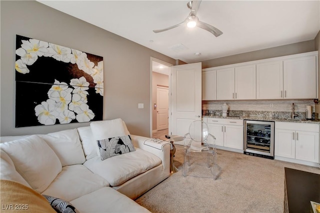 4336 Guava Ct Unit 0, Las Vegas, NV 89135 - living room with wine cooler, wet bar, a ceiling fan, and light colored carpet