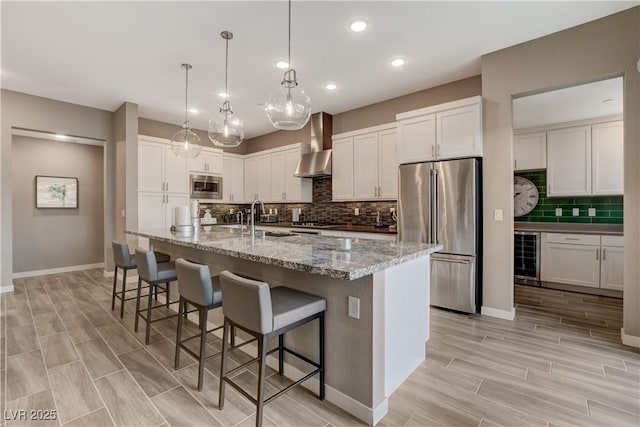 4336 Guava Ct Unit 0, Las Vegas, NV 89135 - kitchen featuring stainless steel appliances, wall chimney exhaust hood, wine cooler, tasteful backsplash, and wood finish floors