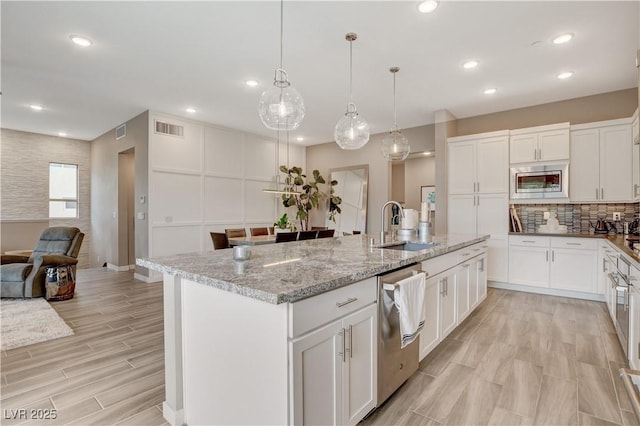 4336 Guava Ct Unit 0, Las Vegas, NV 89135 - kitchen with stainless steel appliances, white cabinetry, decorative backsplash, light stone countertops, and recessed lighting