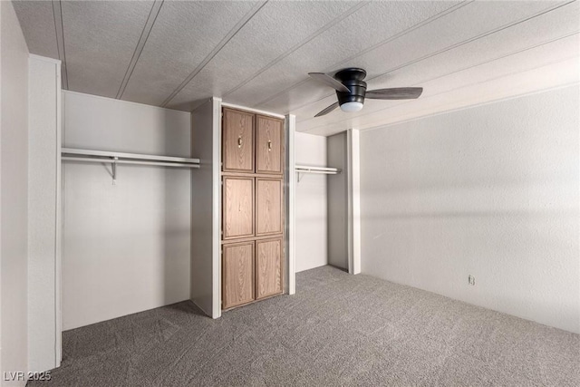 3471 Cape Cod Dr, Las Vegas, NV 89122 - unfurnished bedroom with dark carpet, a closet, a textured ceiling, and ceiling fan