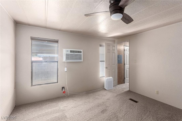 3471 Cape Cod Dr, Las Vegas, NV 89122 - spare room featuring a wall mounted AC, a ceiling fan, and carpet floors