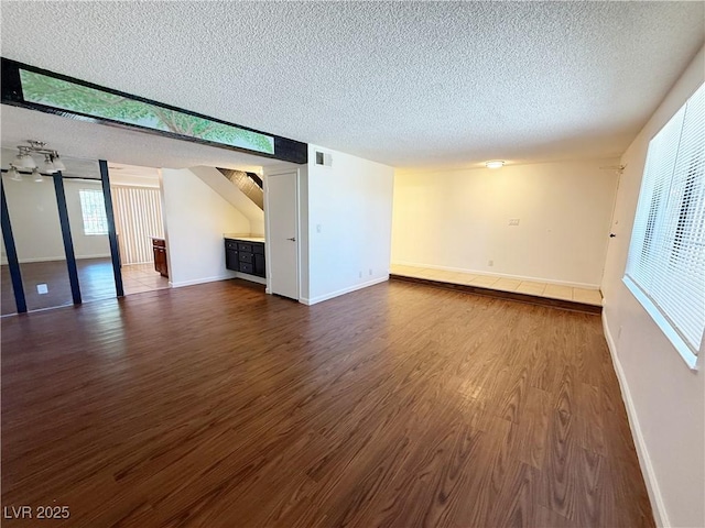 3270 Liahona Way, Las Vegas, NV 89121 - unfurnished living room with a textured ceiling and dark wood finished floors