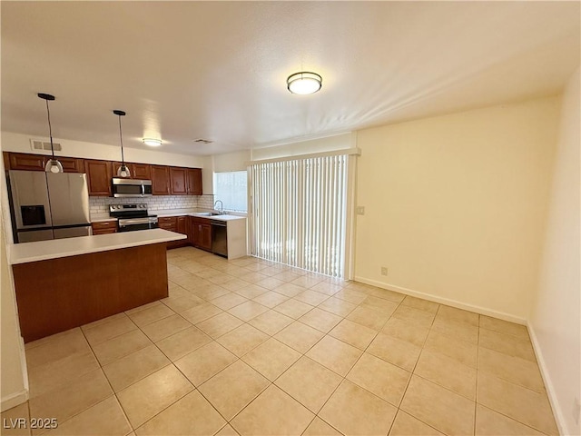 3270 Liahona Way, Las Vegas, NV 89121 - kitchen featuring stainless steel appliances, light countertops, light tile patterned flooring, and decorative backsplash