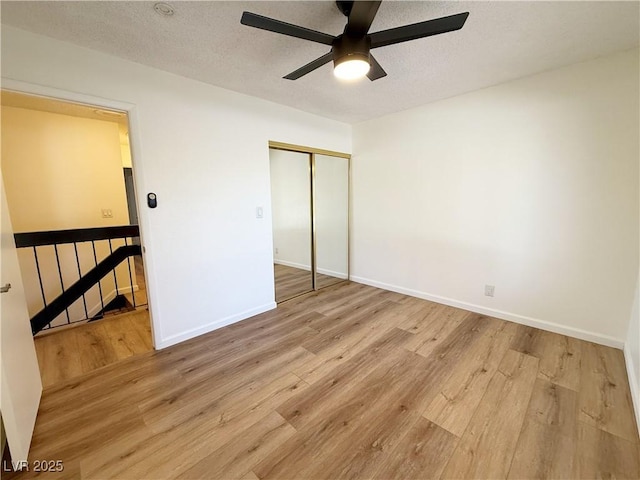3270 Liahona Way, Las Vegas, NV 89121 - unfurnished bedroom featuring wood finished floors, a closet, a ceiling fan, and a textured ceiling